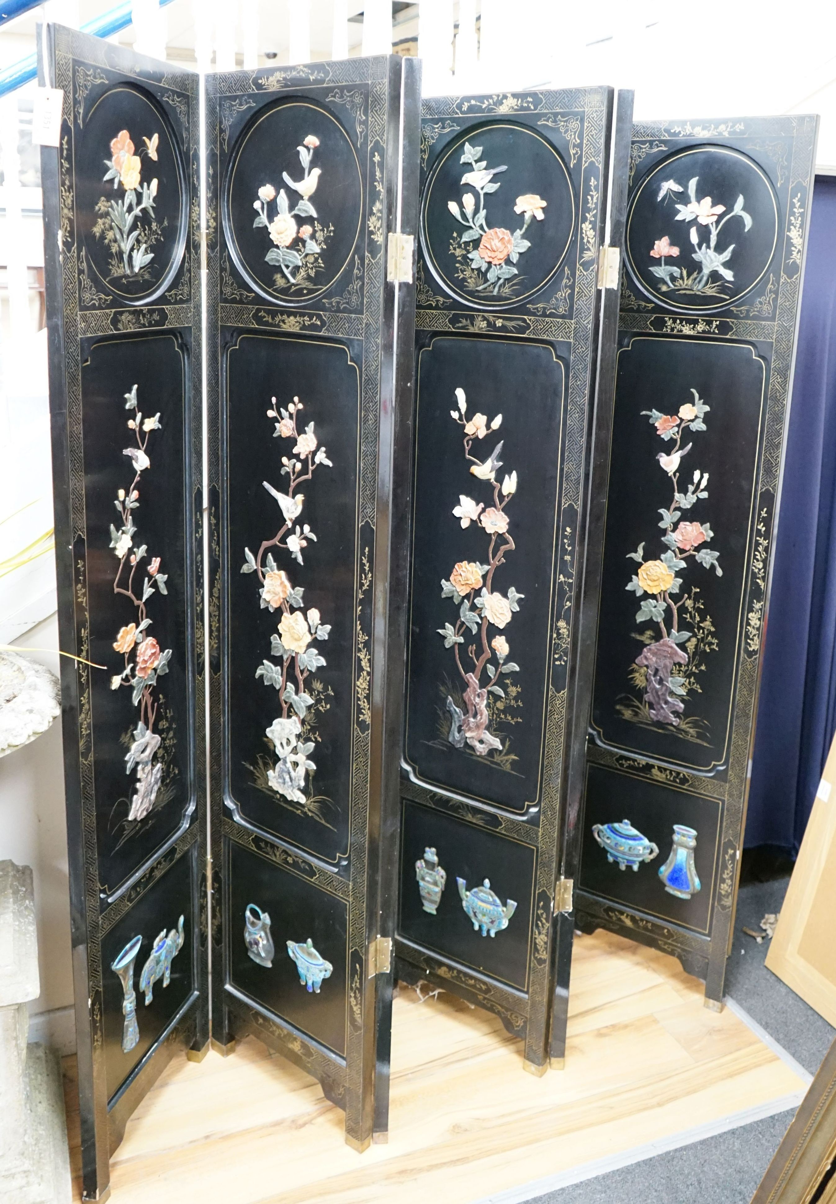 A Chinese ebonised hardstone and enamel mounted six fold dressing screen, each panel width 40cm, height 183cm